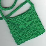 a little green purse for sophie. a quickie so i could learn the long-tail cast on and icords. she calls it her pocket.